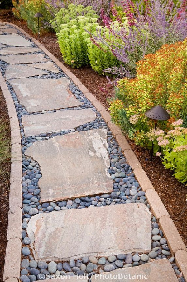 A pathway lined in brick with stepping stones and pebble filler...brilliant.