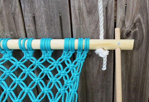 String the rope through the top of the frame and tie a loose knot.
