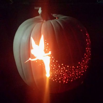 Tinker Bell Pixie Dust Pumpkin Carving - trace Tinker Bell image to pumpkin, cut out; use different drill bits to create pixie dust!