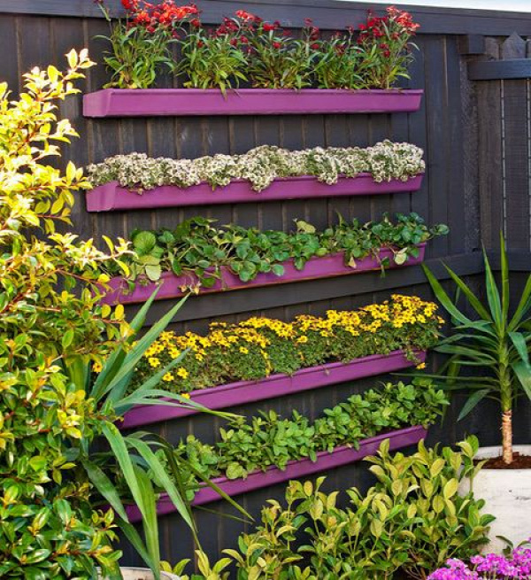 How to build a vertical gutter garden -- No matter how basic your DIY ability, it’s easy to create a great feature wall. Here, we’ve planted up cost-saving PVC gutters and arranged them in tiers, on a painted fence, with brilliant results.