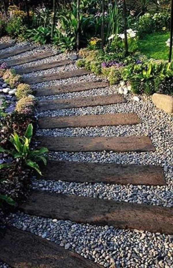 Used railroad ties ( or 4x4s ) and pea gravel--- id like to put this path thru my garden......