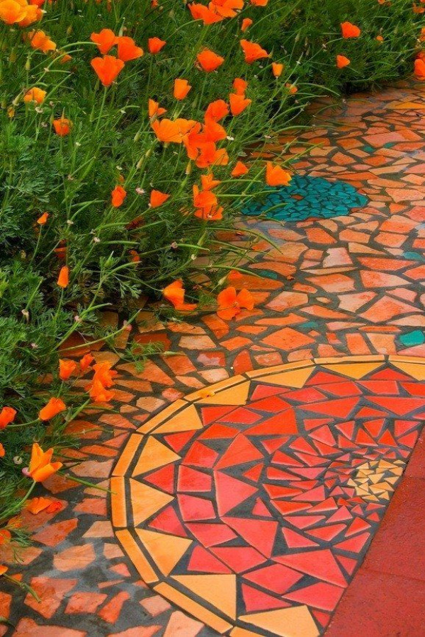 Love the combination here ... the gorgeous orange in the mosaic picked up by the flowers.