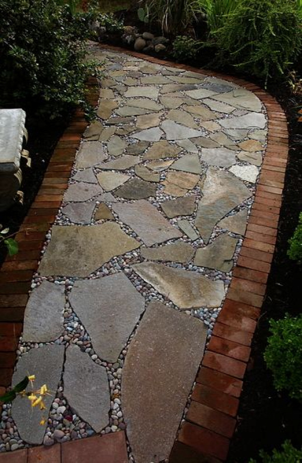 Flagstone path, lined with brick and filled in with river gravel.