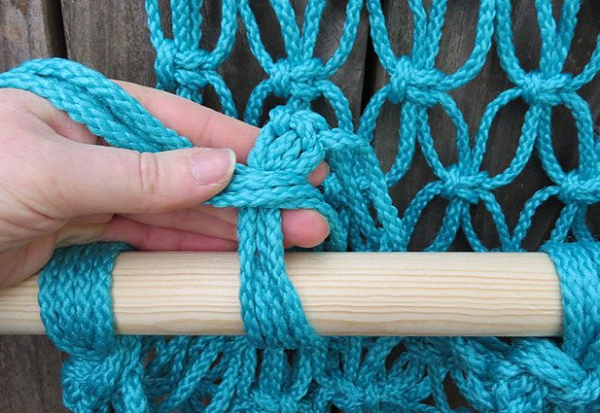 Wrap the cords around the dowel and tie a knot.