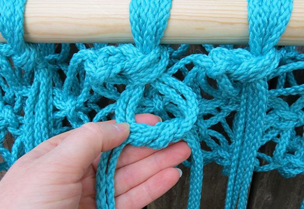 Tie a second knot to secure the cords to the frame.