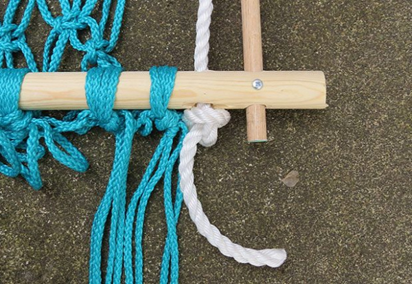 String the rope through bottom of frame and tie a loose knot.