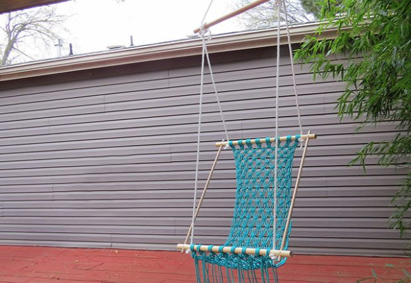 Hang the hammock from a sturdy hook and adjust the ropes.